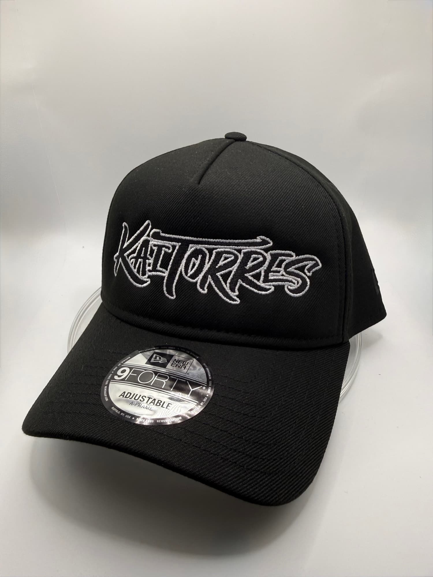 Black New Era 9Forty cap with Kai Torres embroidered in white outline script
